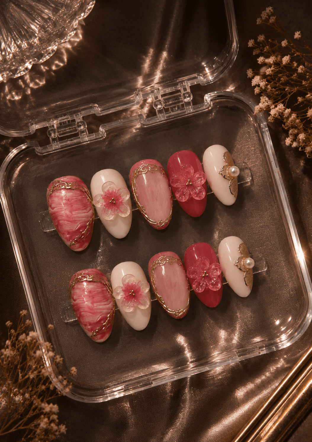 Blush and gold bloom — Soft pink marble nails with delicate gold linework, 3D cherry blossom charms, and pearl accents — a romantic, feminine set with a handcrafted finish.