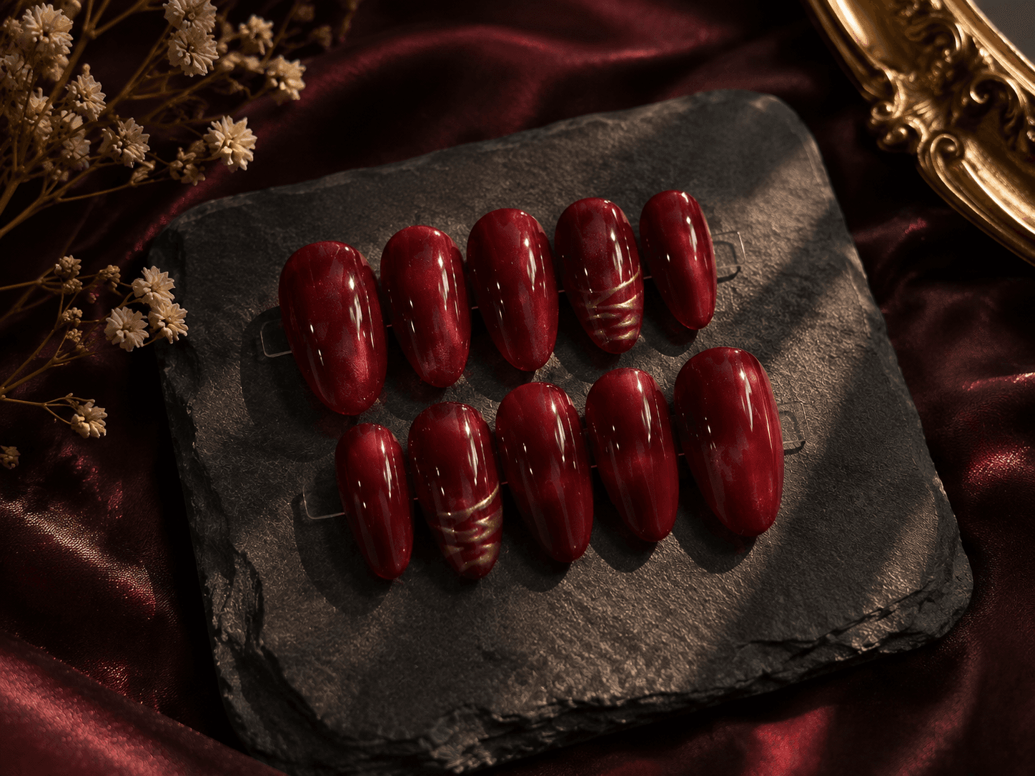 Crimson Gold(Cateye) — Rich shimmering red nails with delicate gold swirls