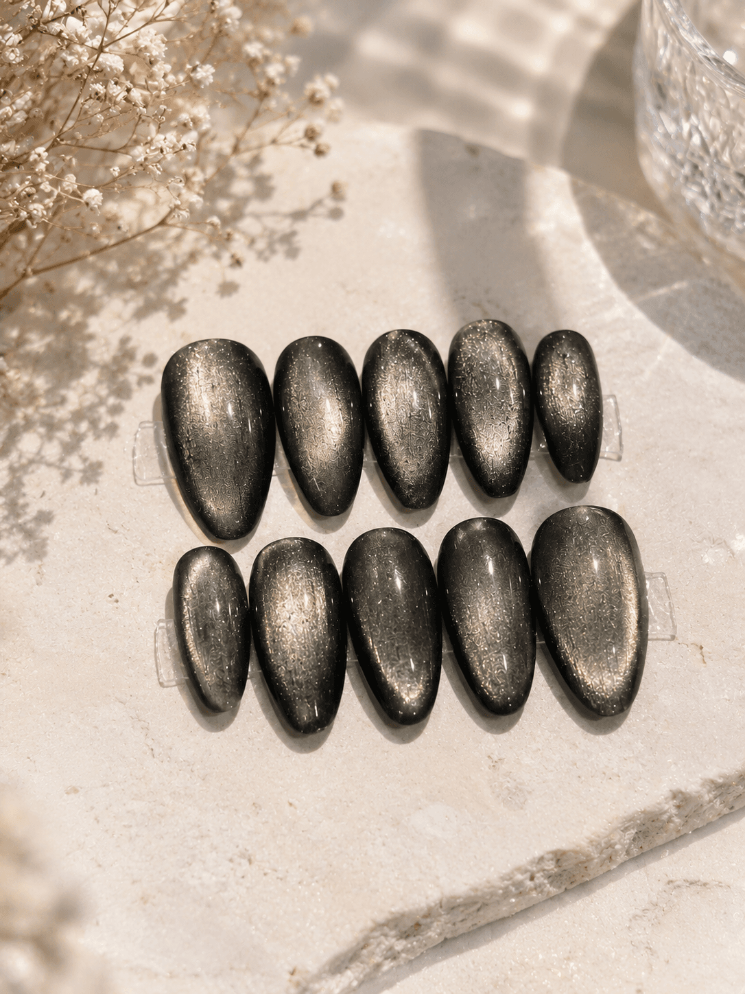 Graphite black Cat Eye — Deep smoky-grey to black cat-eye nails with a metallic shimmer