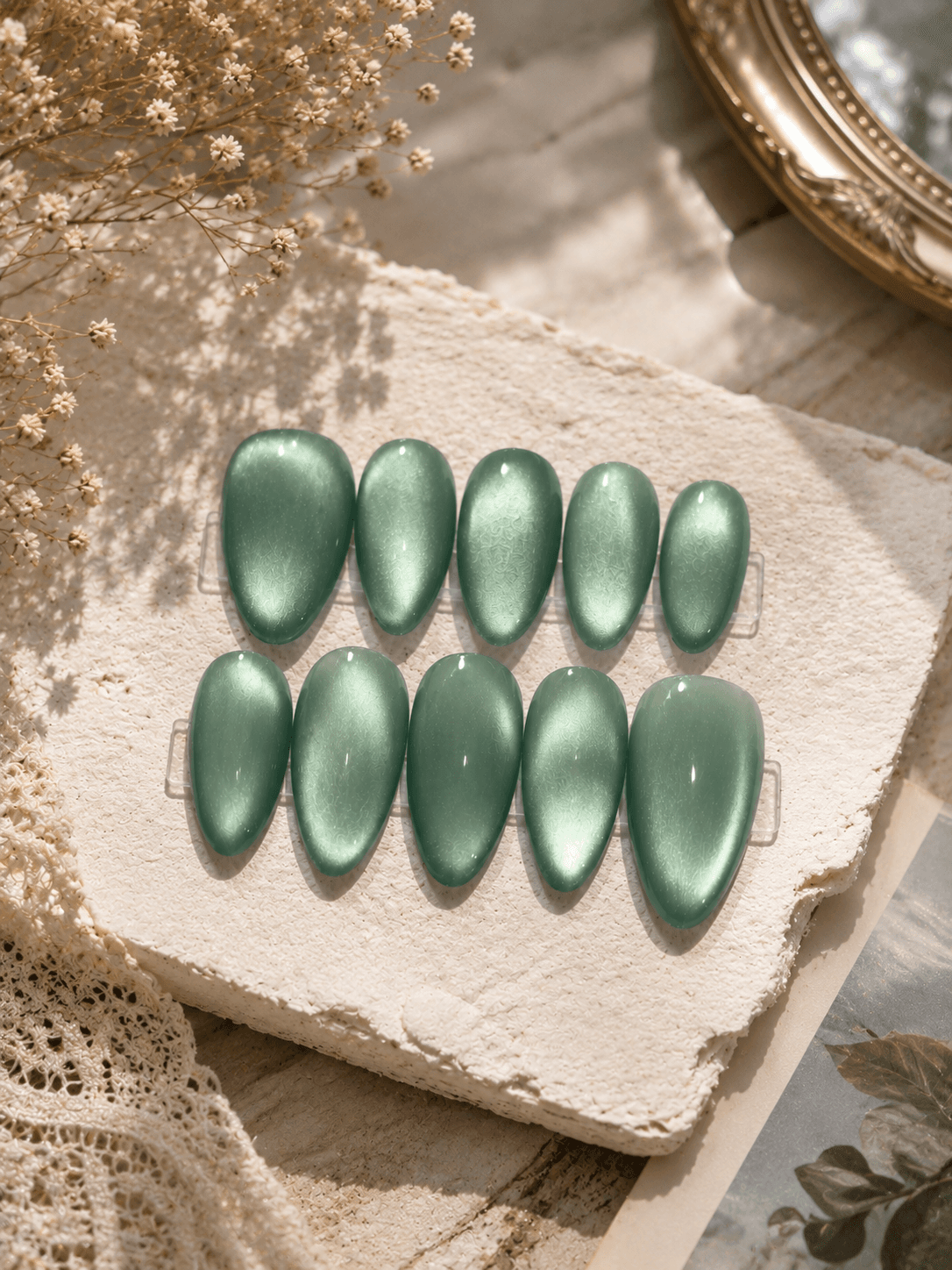 Sage Cat Eye — Shimmering sage-green cat-eye nails with a soft magnetic glow